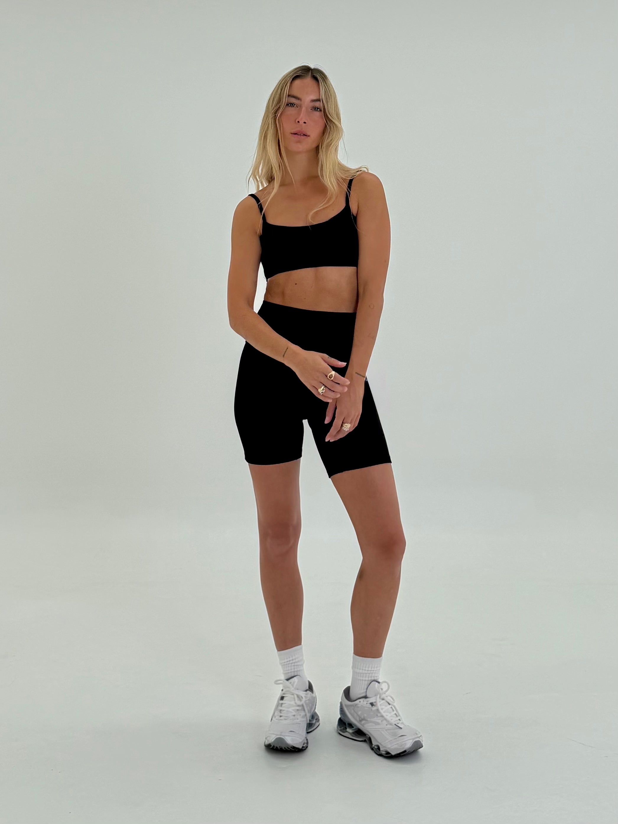 full length front of girl wearing organic black ribbed yoga set